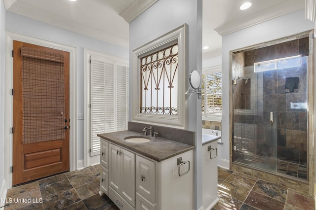 bathroom featuring crown molding, a shower with door, and vanity