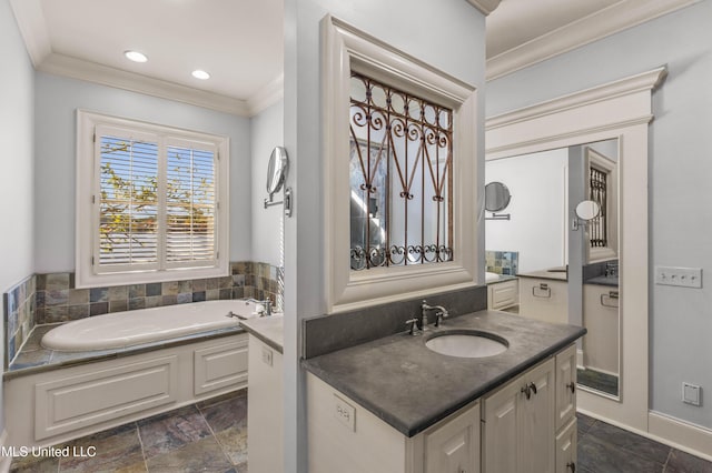 bathroom featuring vanity, ornamental molding, and a tub