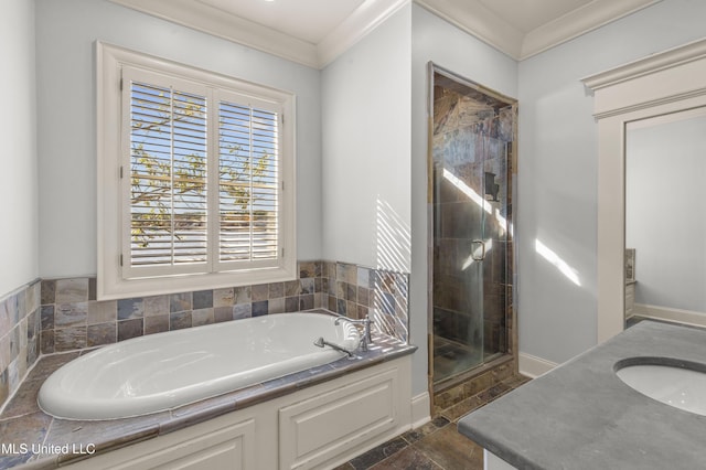 bathroom with separate shower and tub, vanity, and ornamental molding