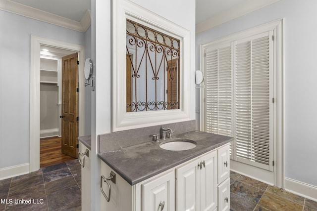 bathroom with crown molding and vanity