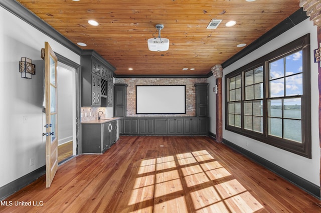 cinema featuring sink, dark hardwood / wood-style flooring, crown molding, and wood ceiling