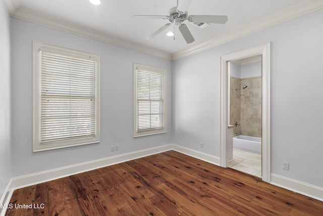 spare room featuring ceiling fan, wood-type flooring, and ornamental molding