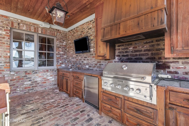 kitchen featuring wooden ceiling, crown molding, stainless steel refrigerator, custom range hood, and brick wall