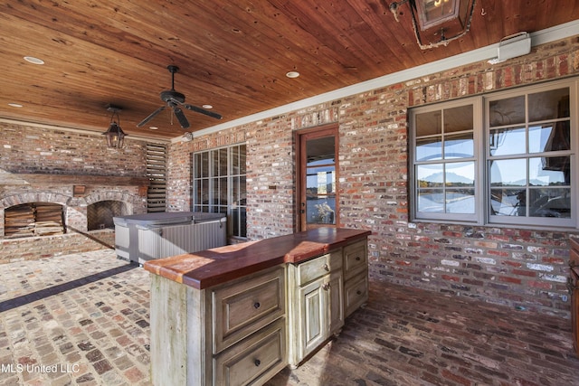 view of patio featuring ceiling fan and an outdoor kitchen