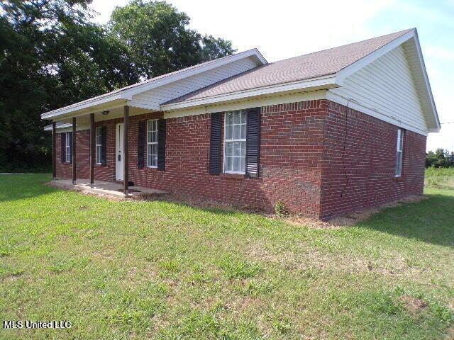 ranch-style house with brick siding and a front lawn