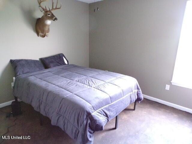 carpeted bedroom with baseboards