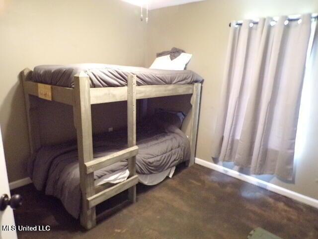 carpeted bedroom featuring baseboards