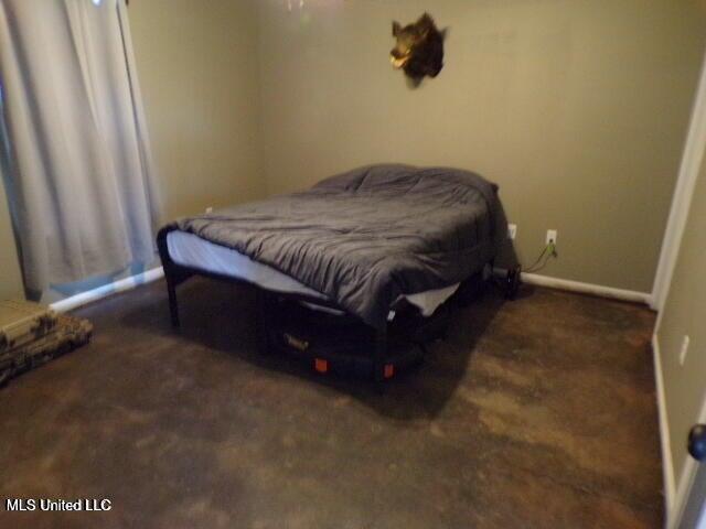 bedroom with baseboards and carpet flooring