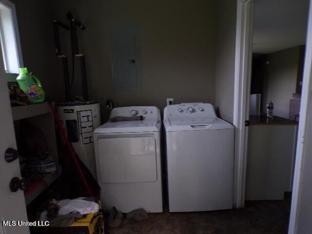 washroom with electric panel, washer and dryer, and laundry area