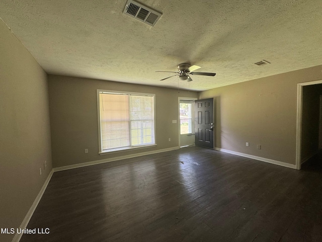 1010 Deryll St, Jackson, MS 39212 - empty room featuring a textured ceiling, dark wood-style flooring, a ceiling fan, and baseboards