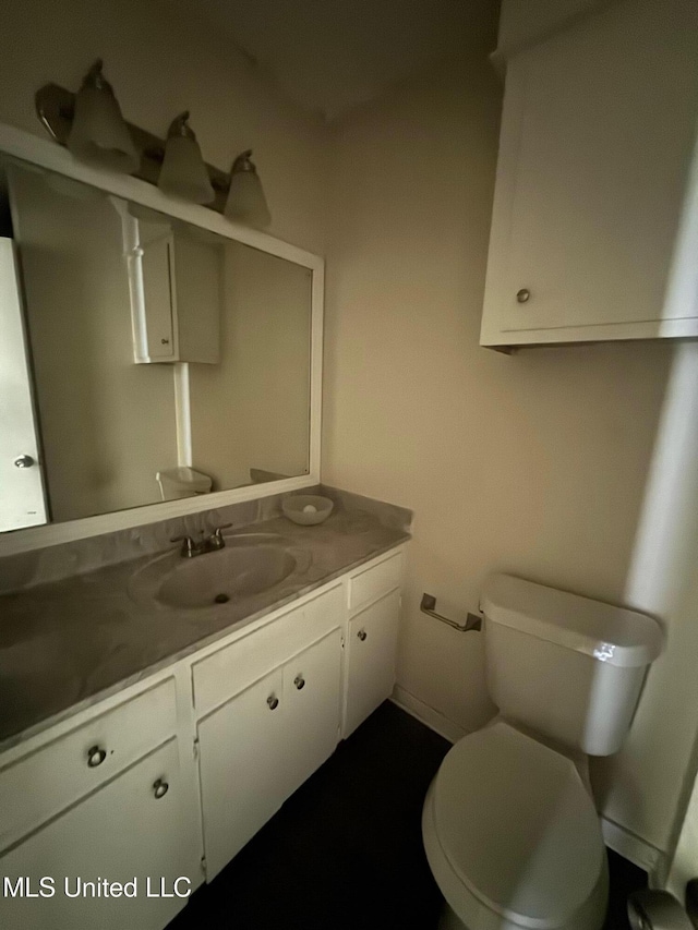 1010 Deryll St, Jackson, MS 39212 - half bathroom with vanity, toilet, and baseboards