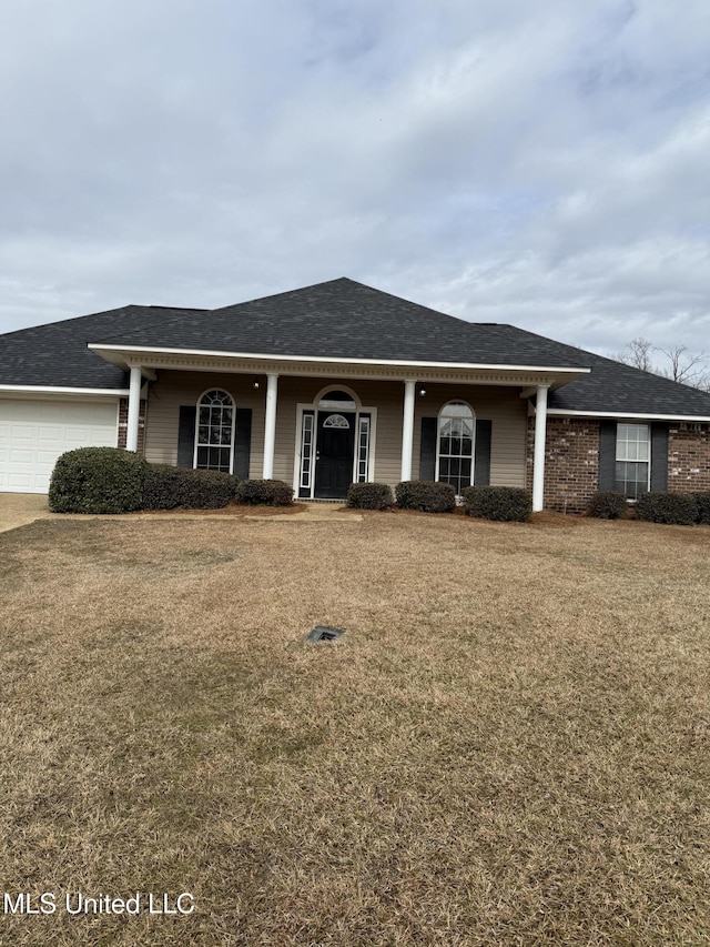 ranch-style home with a garage and a front yard