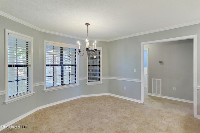 spare room featuring a notable chandelier, ornamental molding, and a textured ceiling