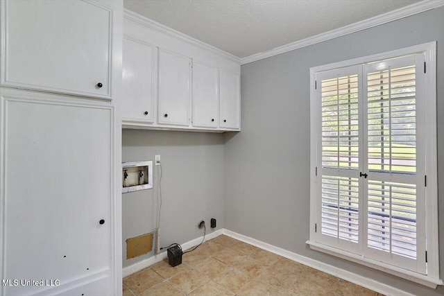 washroom featuring washer hookup, a healthy amount of sunlight, ornamental molding, and cabinets