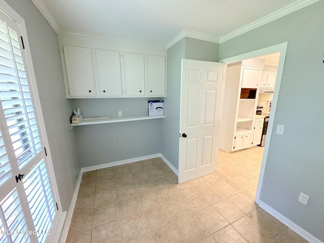 laundry area featuring ornamental molding and light tile patterned flooring