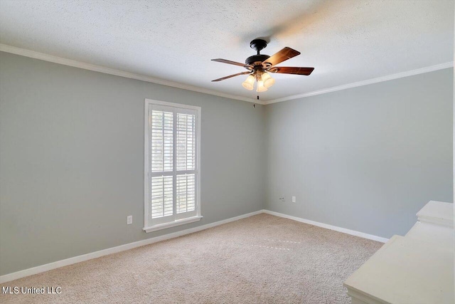 spare room featuring ornamental molding, ceiling fan, a textured ceiling, and carpet flooring