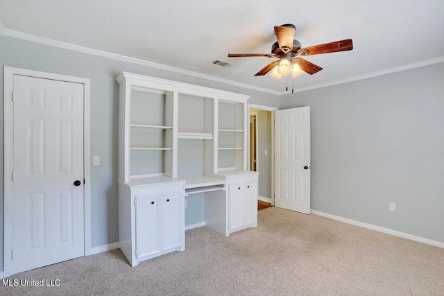 unfurnished bedroom with crown molding, light colored carpet, and ceiling fan