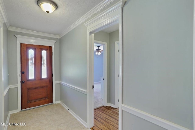 entrance foyer with crown molding, a textured ceiling, light hardwood / wood-style flooring, and ceiling fan