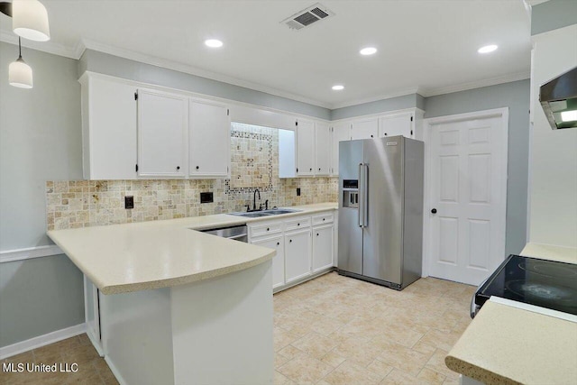 kitchen featuring white cabinets, tasteful backsplash, appliances with stainless steel finishes, sink, and decorative light fixtures