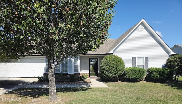 obstructed view of property with a shingled roof, an attached garage, and a front yard