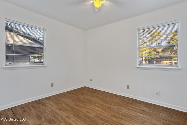 empty room featuring ceiling fan and hardwood / wood-style floors