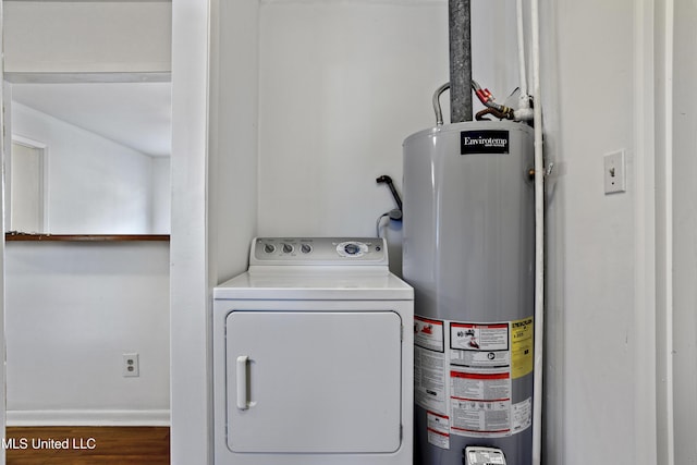 clothes washing area featuring washer / clothes dryer, hardwood / wood-style floors, and gas water heater