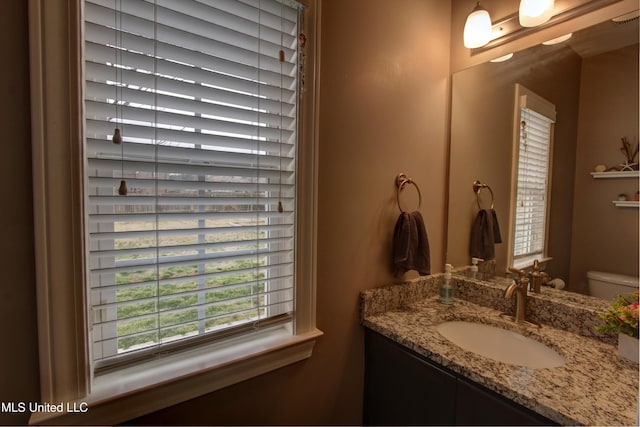 half bathroom featuring toilet and vanity