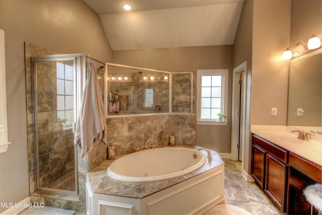 bathroom with lofted ceiling, a stall shower, vanity, and a whirlpool tub