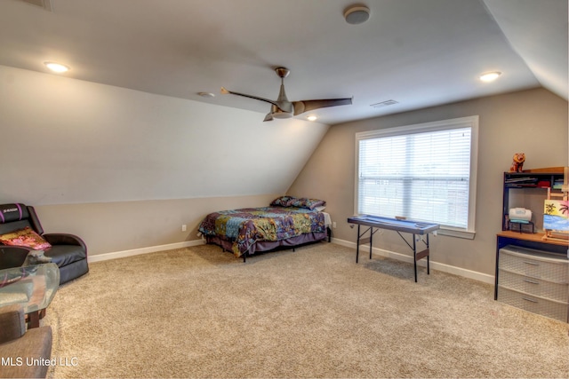 carpeted bedroom featuring lofted ceiling, a ceiling fan, visible vents, and baseboards