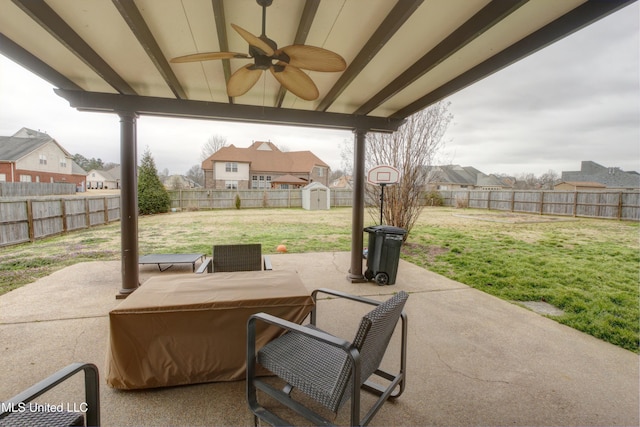 view of patio / terrace with a storage unit, an outdoor structure, a fenced backyard, and a residential view