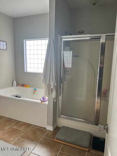 bathroom featuring separate shower and tub