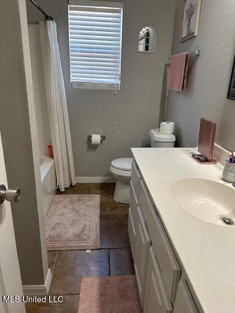 full bathroom featuring tile patterned floors, shower / bath combo, toilet, and vanity