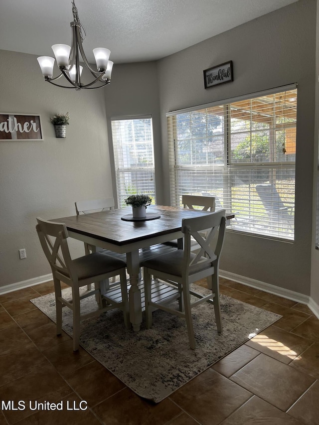 tiled dining room featuring an inviting chandelier