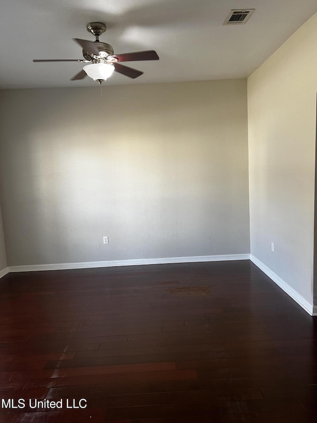 empty room featuring dark hardwood / wood-style floors and ceiling fan