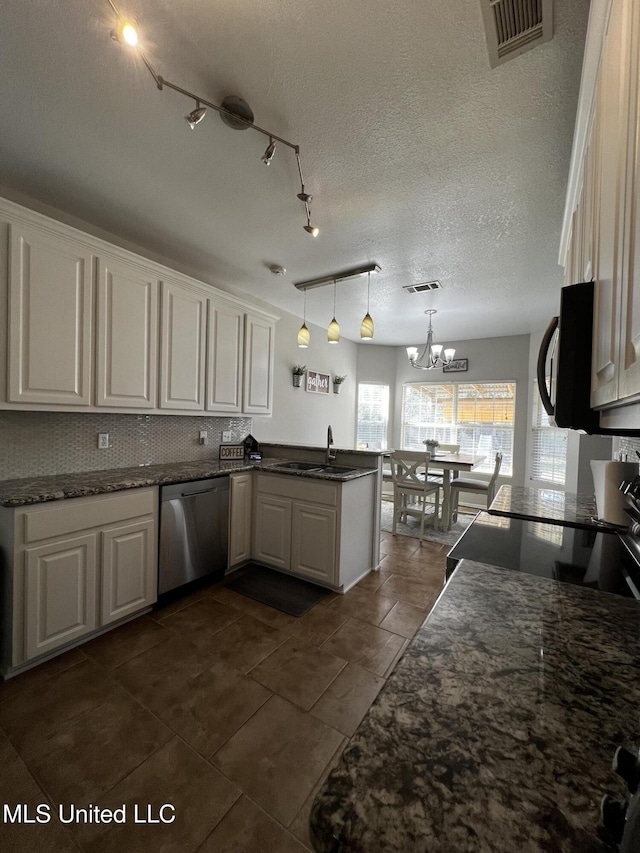 kitchen featuring dishwasher, white cabinets, hanging light fixtures, kitchen peninsula, and a chandelier