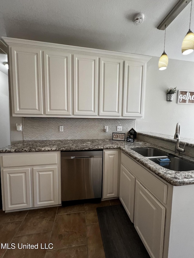 kitchen featuring stainless steel dishwasher, decorative light fixtures, white cabinetry, and sink