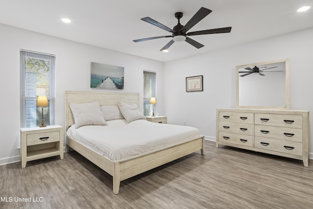 bedroom with light wood-type flooring, ceiling fan, baseboards, and recessed lighting