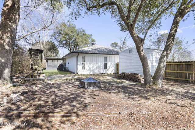 rear view of house with fence and cooling unit