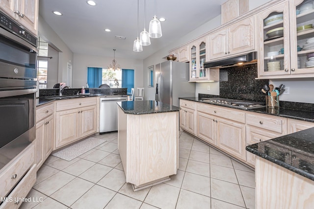 kitchen with pendant lighting, appliances with stainless steel finishes, light tile patterned flooring, and a kitchen island