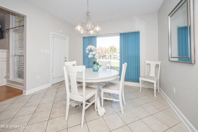 tiled dining room with a notable chandelier