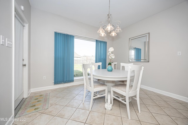 dining area with light tile patterned floors and a chandelier