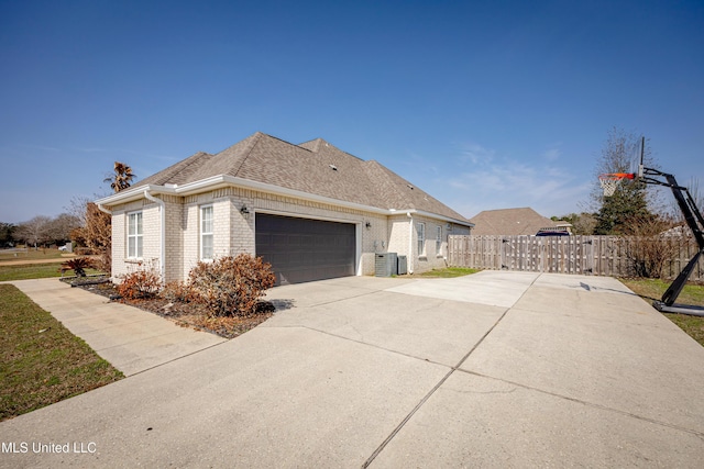 view of property exterior featuring a garage and central AC