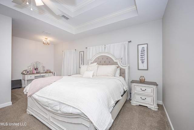 bedroom with a raised ceiling, crown molding, and carpet floors