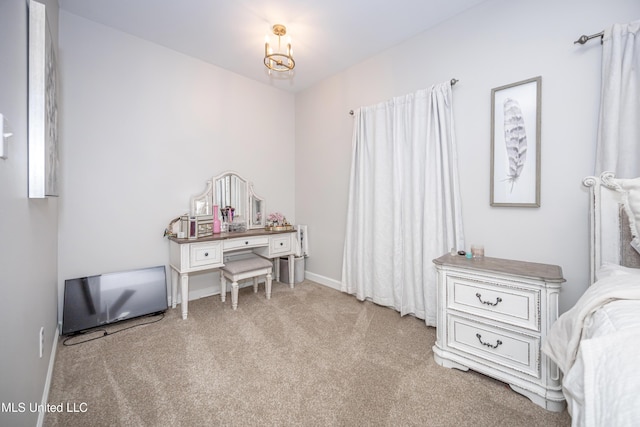 carpeted bedroom with an inviting chandelier