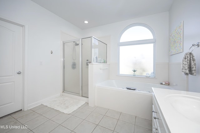 bathroom with vanity, tile patterned floors, and shower with separate bathtub