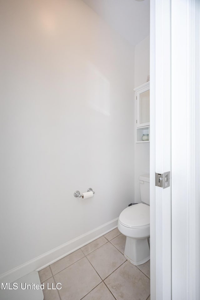 bathroom with toilet and tile patterned flooring