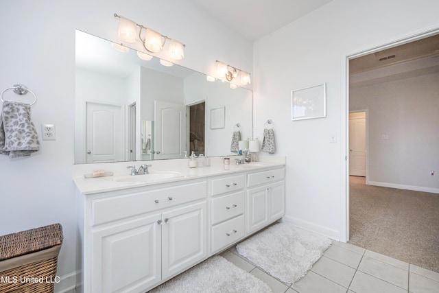 bathroom with tile patterned floors and vanity