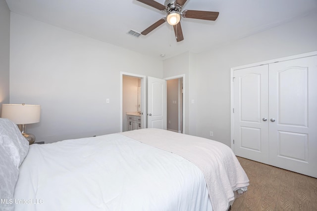 bedroom with ceiling fan, light wood-type flooring, and a closet