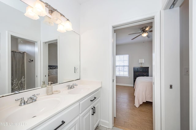 bathroom featuring ceiling fan, wood-type flooring, and vanity