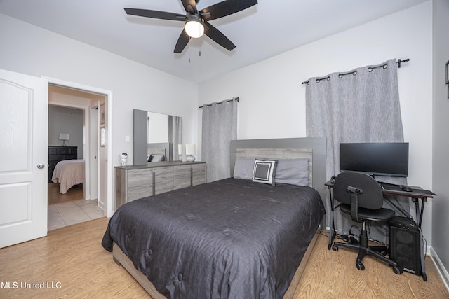 bedroom featuring ceiling fan, connected bathroom, and light wood-type flooring